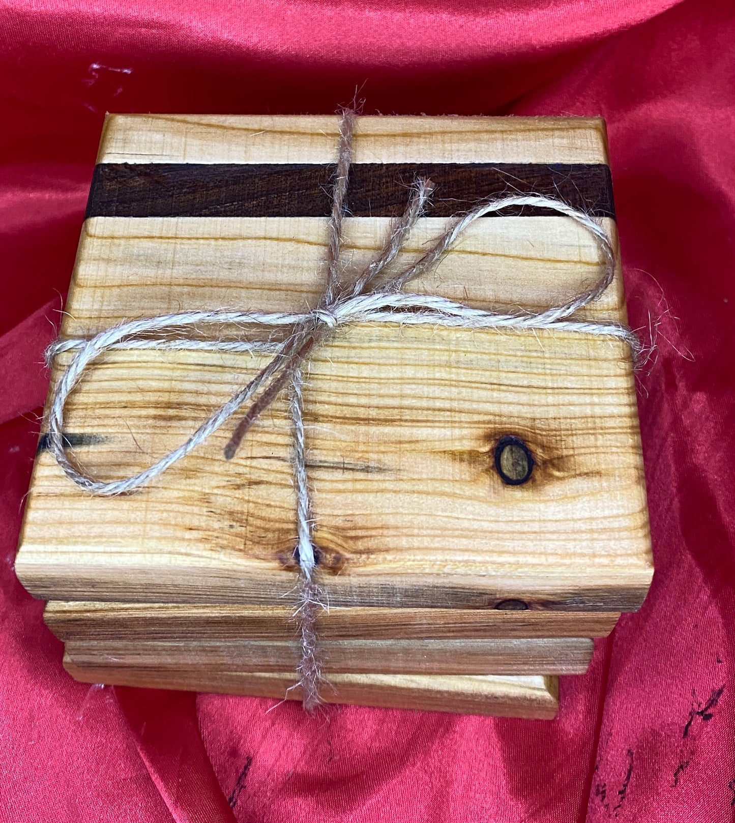 Wooden coasters with mahogany inlay.